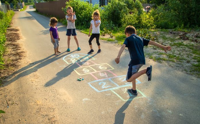 Kids playing hopscotch in the street