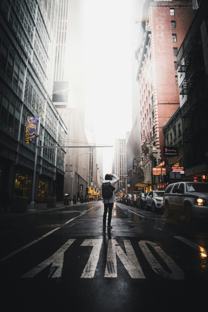 person taking photo of buildings in NYC